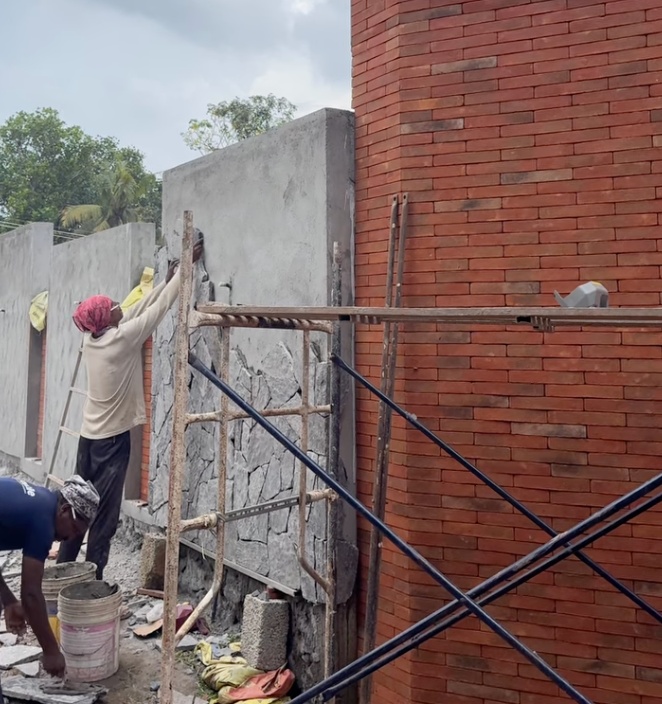 Exterior plastering beside brick cladding in Siolim
